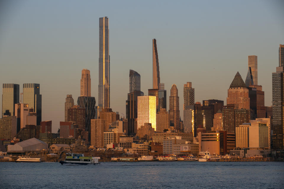 FILE - Light from the setting sun reflects off the buildings in the borough of Manhattan in New York, as seen from the Weehawken Pier in Weehawken, N.J., on Wednesday, March 22, 2023. The ground rumbled Friday, April 5, 2024, beneath New York City, home to famous skyscrapers like the Empire State Building and One World Trade Center. Though buildings that can reach above 100 stories might seem especially vulnerable to earthquakes, engineering experts say they're built with enough flexibility to withstand them. (AP Photo/Ted Shaffrey, File)