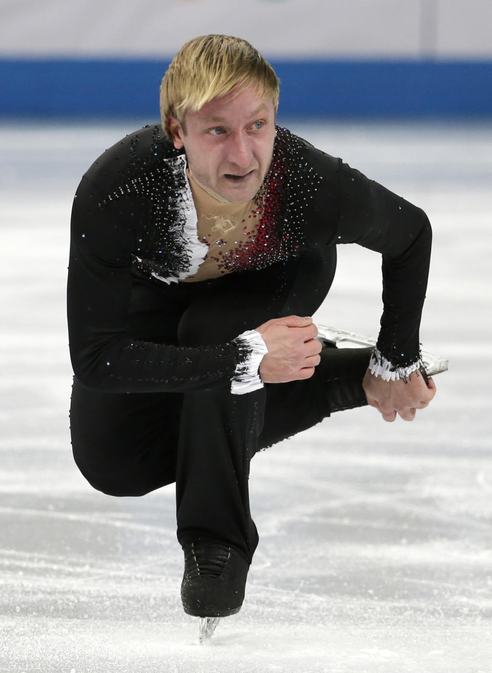 Evgeny Plyushchenko of Russia competes in the men's team short program figure skating competition at the Iceberg Skating Palace during the 2014 Winter Olympics, Thursday, Feb. 6, 2014, in Sochi, Russia. (AP Photo/Bernat Armangue)