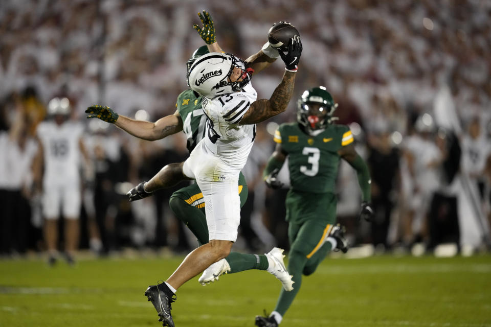 Iowa State wide receiver Jaylin Noel (13) catches a pass in front of Baylor safety Caleb Parker, left, and safety Devyn Bobby (3) during the first half of an NCAA college football game, Saturday, Oct. 5, 2024, in Ames, Iowa. (AP Photo/Charlie Neibergall)