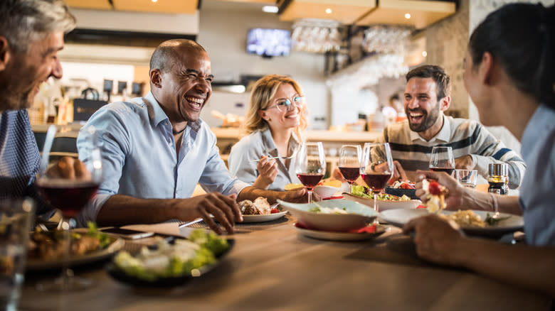 people at table in restaurant laughing