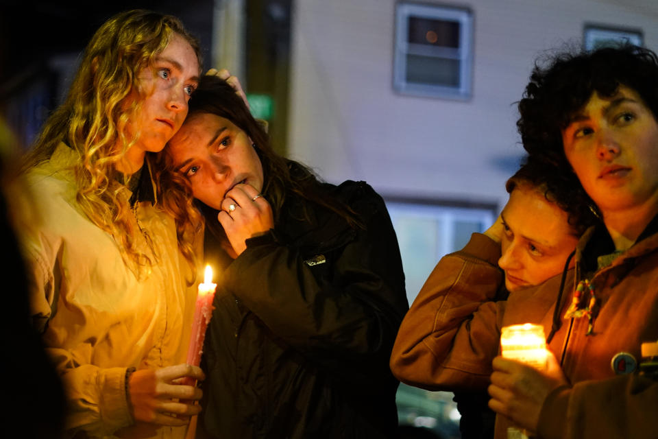 People linger after a vigil for the victims of Wednesday's mass shootings, Sunday, Oct. 29, 2023, outside the Basilica of Saints Peter and Paul in Lewiston, Maine. (AP Photo/Matt Rourke)