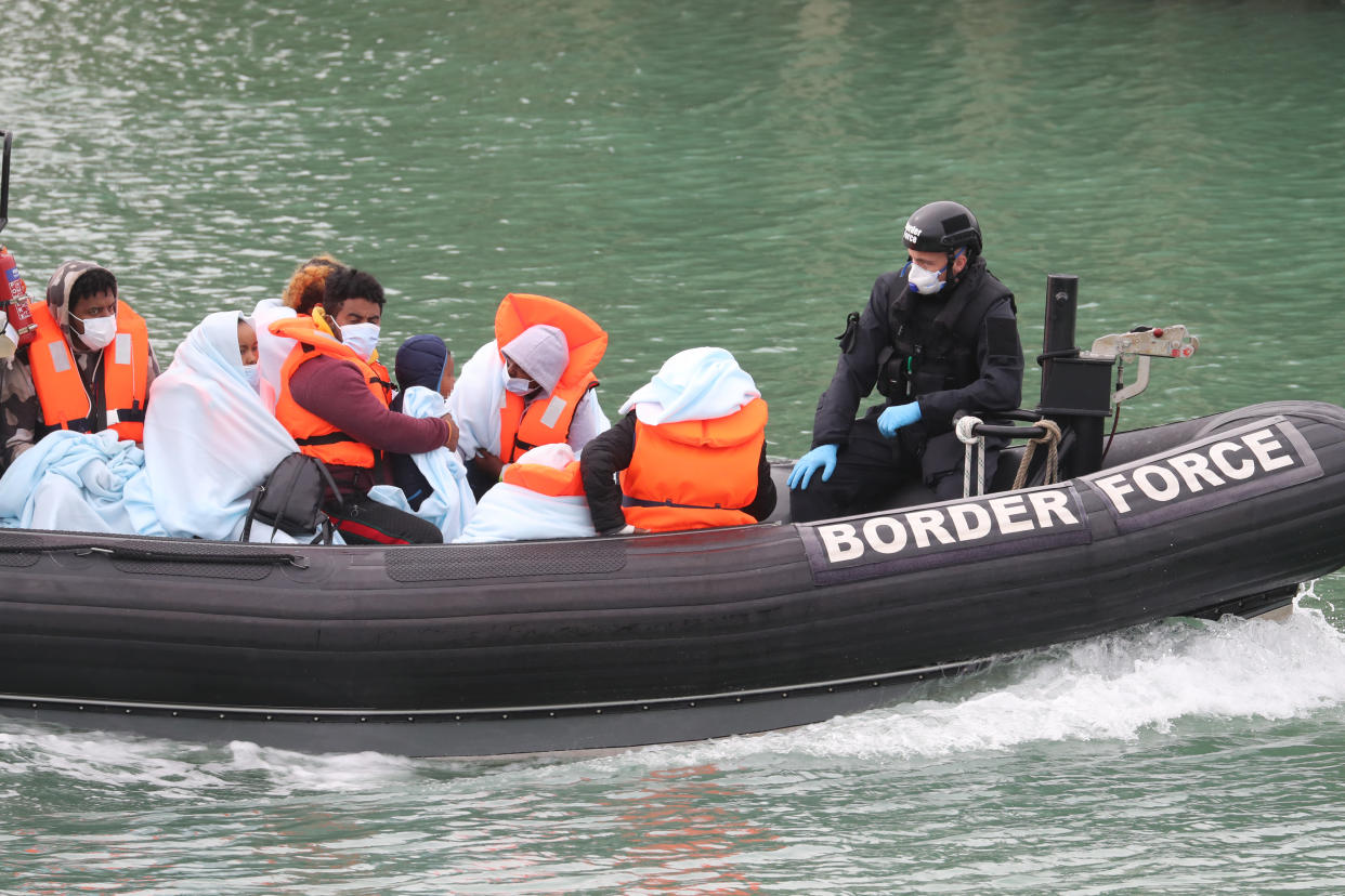 EDITORS NOTE: IMAGE PIXELATED BY PA PICTURE DESK A group of people thought to be migrants are brought into Dover, Kent, by Border Force officers following a small boat incident in the Channel.