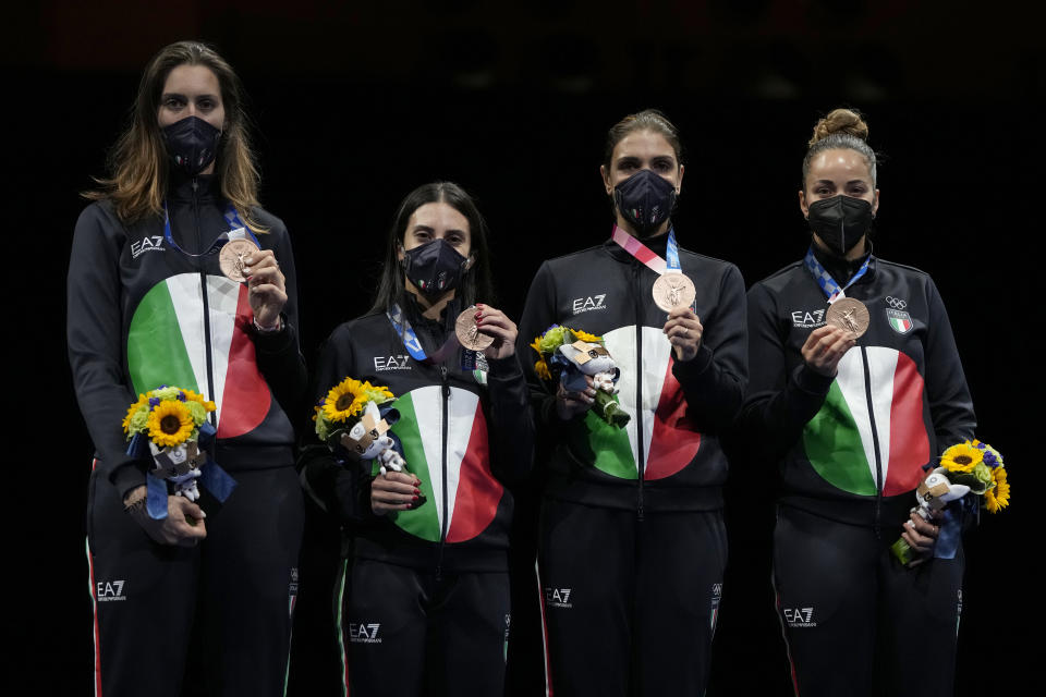 Bronze medalists from Italy celebrate on the podium of the women's Foil team final at the 2020 Summer Olympics, Thursday, July 29, 2021, in Chiba, Japan. (AP Photo/Hassan Ammar)