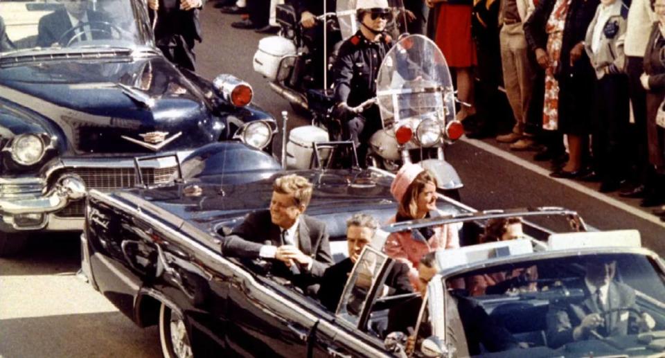 JFK and his wife Jackie in their car before the assassination