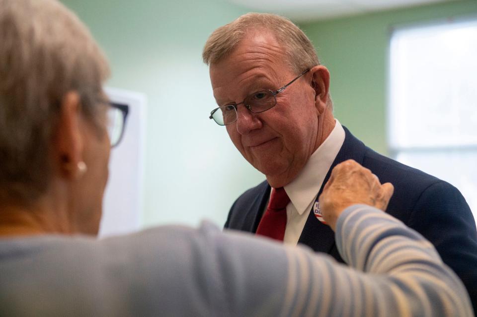 A poll worker gives Jackson County Sheriff Mike Ezell, the Republican candidate for Mississippi’s 4th Congressional District, a voting sticker after he voted at First Presbyterian Church in Pascagoula on Tuesday, Nov. 8, 2022. 