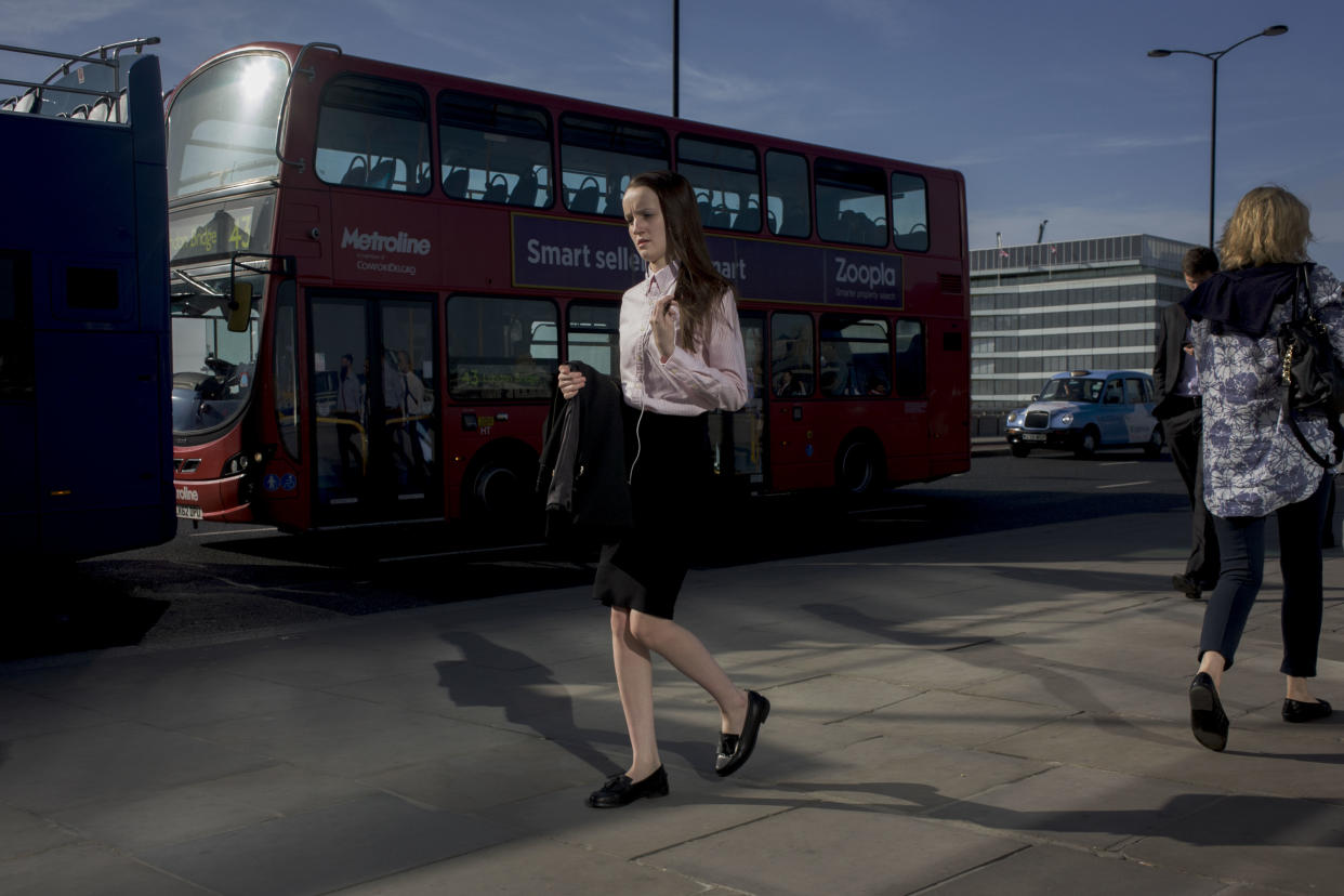 Londoners cross southbound over London Bridge during the evening rush hour. A young woman looks lost in thought as she strides alongside a bus, followed by others walking out of the City of London. There has been a crossing over the Thames here since the Romans first forded the river in the early 1st Century with subsequent medieval and Victorian stone bridges becoming an important thoroughfare from the City on the north bank, to Southwark on the south where transport hubs such as the mainline s (Photo by In Pictures Ltd./Corbis via Getty Images)