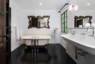 <p>A black floor adds drama to this bathroom. </p>