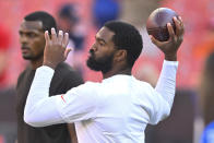 Cleveland Browns quarterback Jacoby Brissett (7), right, warms up beside Deshaun Watson prior to an NFL preseason football game against the Chicago Bears, Saturday, Aug. 27, 2022, in Cleveland. (AP Photo/David Richard)