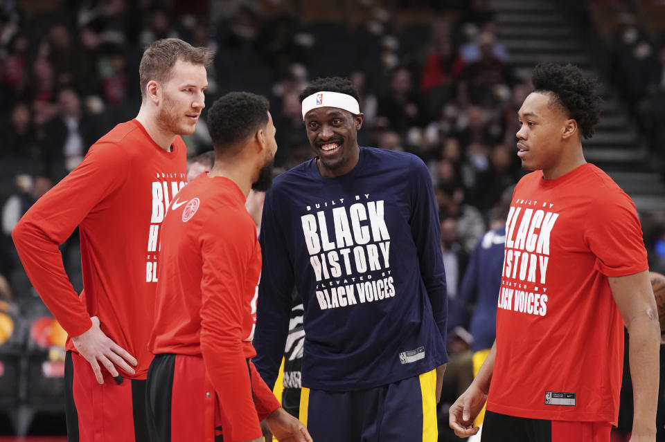 Indiana Pacers' Pascal Siakam, second from right, greets former Toronto Raptors teammates Jakob Poeltl, Garrett Temple and Scottie Barnes, from left, prior to an NBA basketball game Wednesday, Feb. 14, 2024, in Toronto. (Chris Young/The Canadian Press via AP)