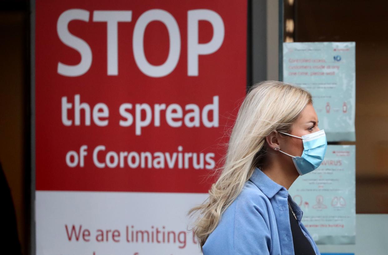 A shopper wears a coronavirus face mask (PA)