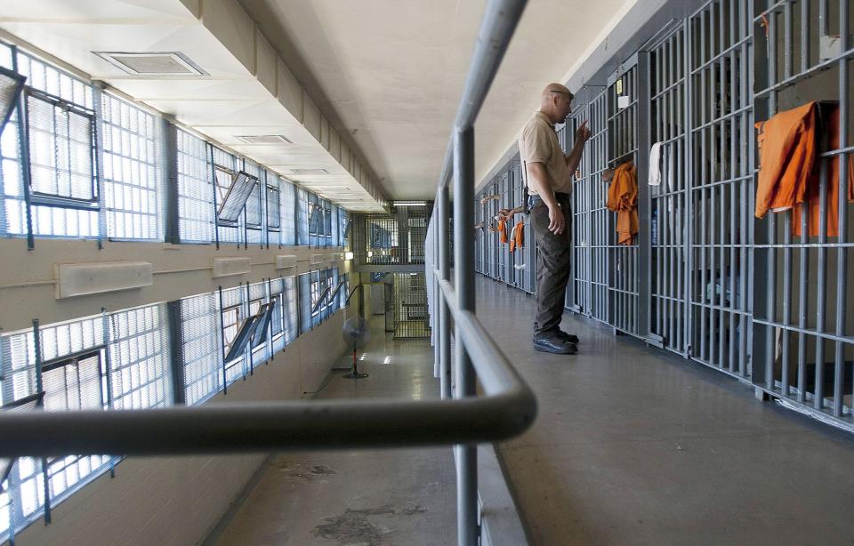 A guard stands at a cell door at the maximum security facility at the Arizona State Prison in Florence.