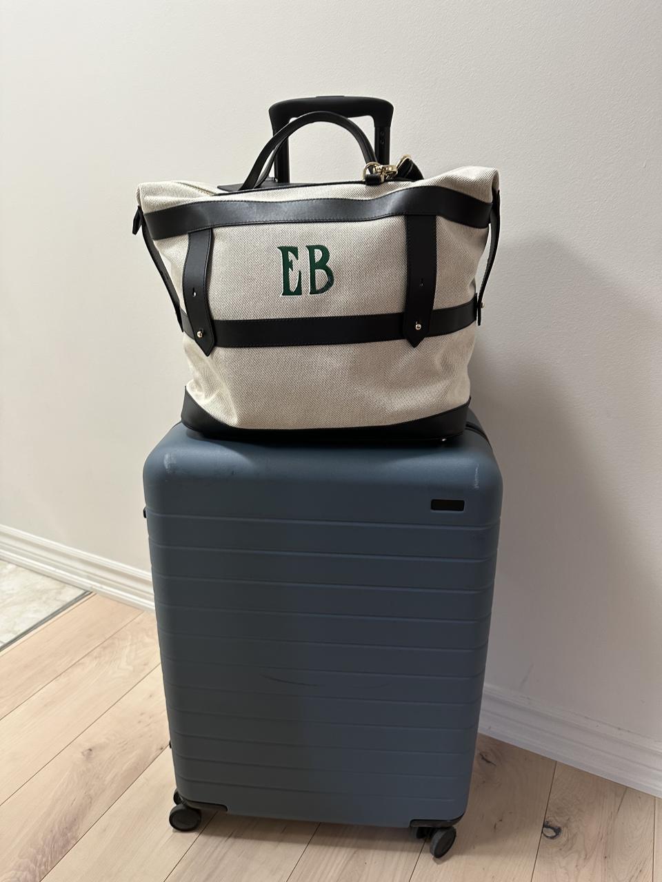 custom Paravel Weekender Bag in white canvas, black leather with EB painted green monogram and navy blue away suitcase (Photo via Author). 