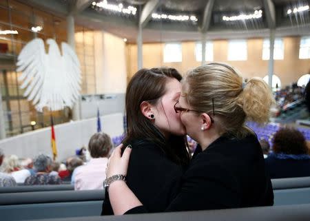 An unidentified couple kisses after a session of the lower house of parliament Bundestag voted on legalising same-sex marriage, in Berlin, Germany June 30, 2017. REUTERS/Fabrizio Bensch