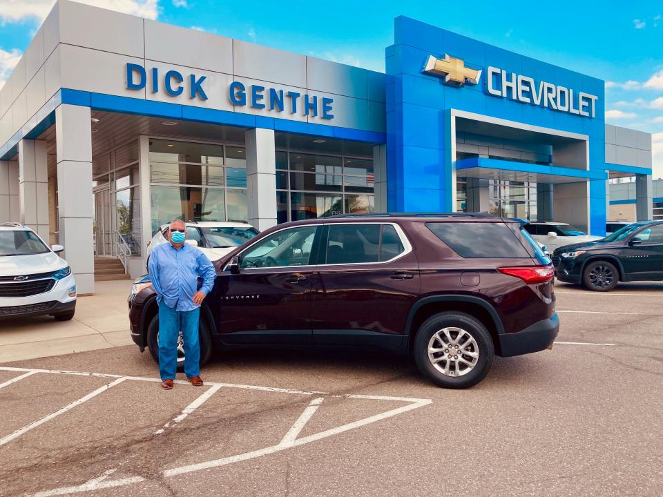 Matthew Kennedy of LaSalle stands by the 2020 Chevrolet Traverse in black cherry he leased from Dick Genthe Chevrolet in Southgate.