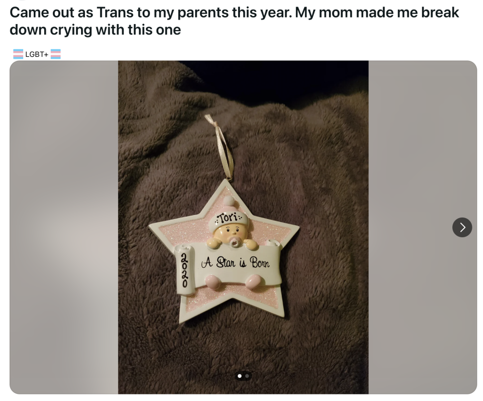 A personalized star-shaped ornament with a teddy bear and text "Tori, A Star is Born" celebrating a child's gender identity