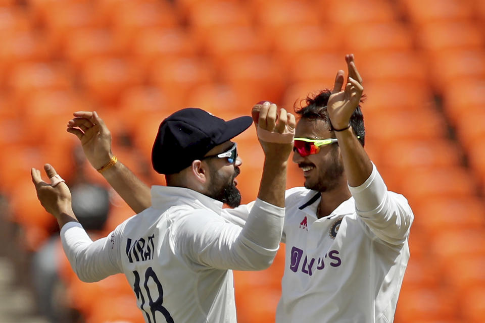 India's Axar Patel, right, celebrates with captain Virat Kohli after the dismissal of England's Ben Stokes during the third day of fourth cricket test match between India and England at Narendra Modi Stadium in Ahmedabad, India, Saturday, March 6, 2021. (AP Photo/Aijaz Rahi)