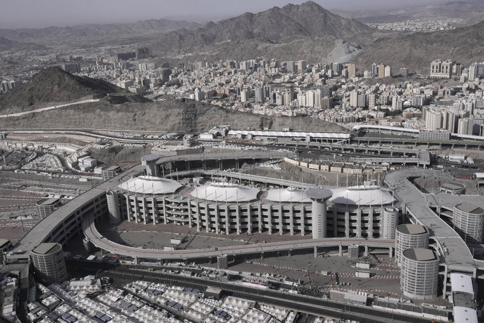 This aerial photo made from a helicopter shows Muslim pilgrims walking to cast stones at pillars in the symbolic stoning of the devil, the last rite of the annual Hajj, in Mina near the holy city of Mecca, Saudi Arabia, Friday, June 30, 2023. (AP Photo/Amr Nabil)