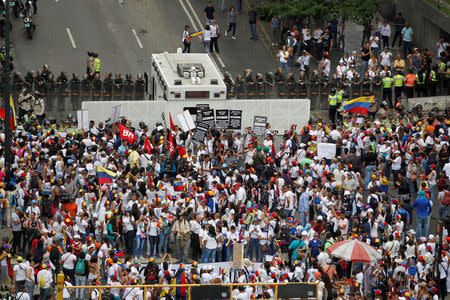 Demonstrators gather in front of the police during a women's march to protest against President Nicolas Maduro's government in Caracas, Venezuela May 6, 2017. REUTERS/Christian Veron