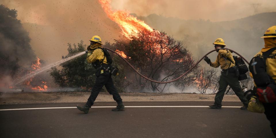 San Miguel County Firefighters battle a brush fire along Japatul Road during the Valley Fire in Jamul, California on September 6, 2020 - The Valley Fire in the Japatul Valley burned 4,000 acres overnight with no containment and 10 structures destroyed, Cal Fire San Diego said. (Photo by SANDY HUFFAKER / AFP) (Photo by SANDY HUFFAKER/AFP via Getty Images)