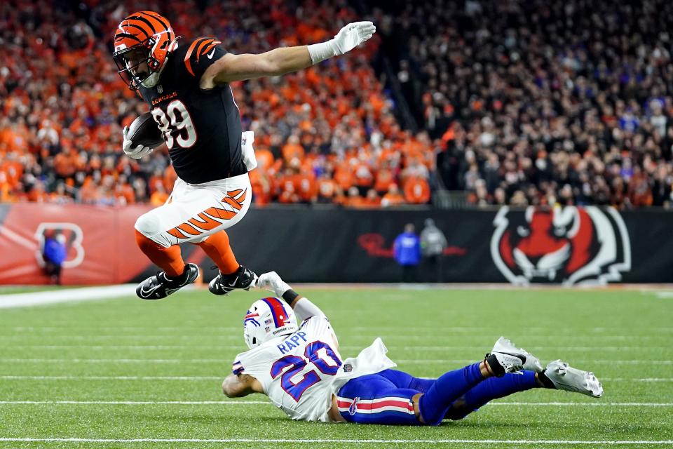 Cincinnati Bengals tight end Drew Sample (89) leaps over Buffalo Bills safety Taylor Rapp (20) on a touchdown catch and run in the second quarter during a Week 9 NFL football game between the Buffalo Bills and the Cincinnati Bengals, Sunday, Nov. 5, 2023, at Paycor Stadium in Cincinnati.