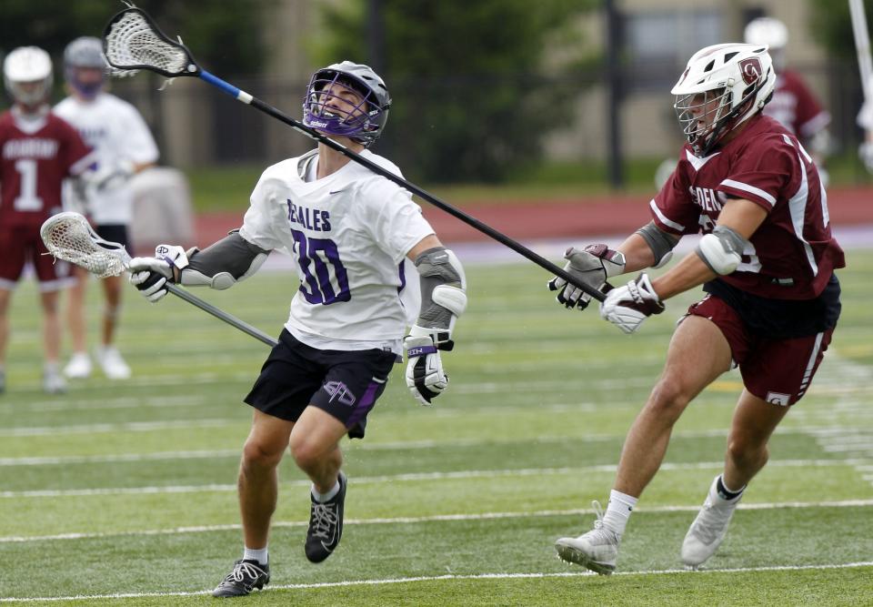 DeSales' Jackson Carawan tries to get past Columbus Academy's Charlie Stoner during the Division II regional final May 27.