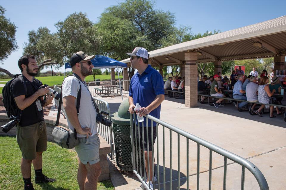 Tyler Bowyer (right), chief operating officer of Turning Point Actions, argues with Arizona Republic’s photographer Antranik Tavitian (left) and Magnum photographer Peter Van Agtmael about the media’s right to document a get-out-the-vote rally organized by Turning Point Action in Mesa on July 30, 2022.