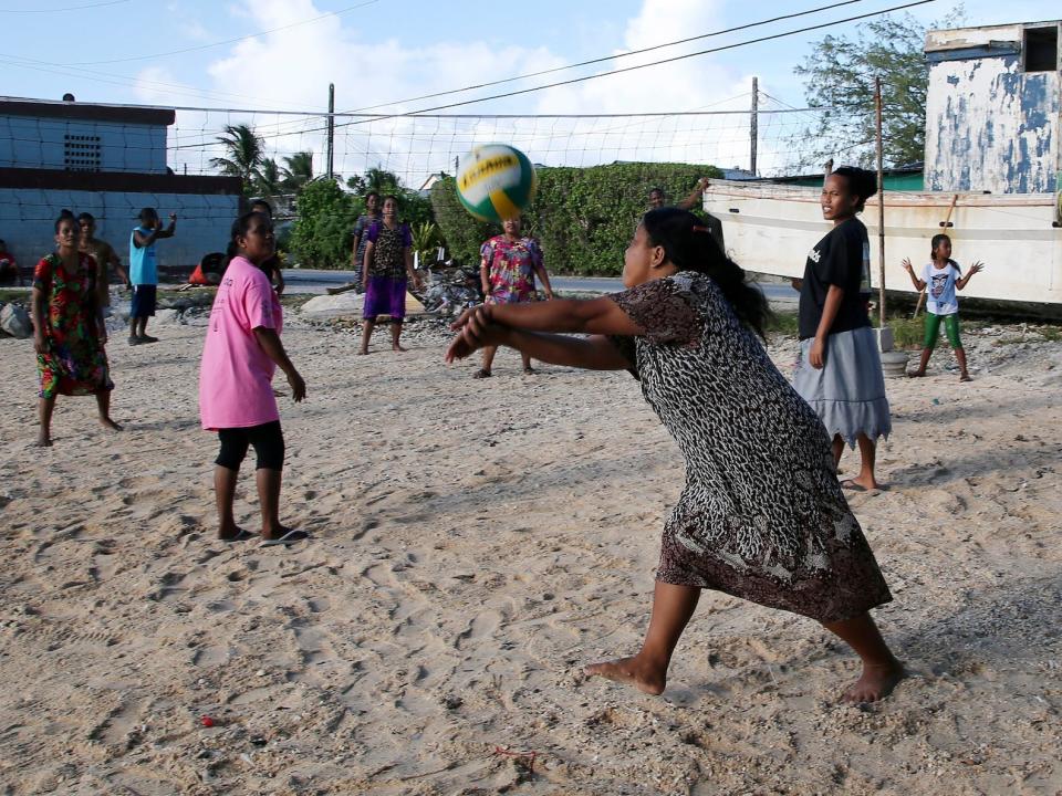 Mothers and children enjoy an afternoon game of volleyball on a beach in Majuro Atoll in the Marshall Islands on Nov. 9, 2015.