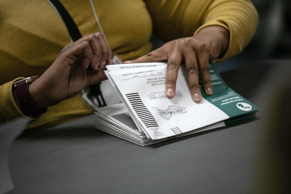 Election workers sort absentee ballots to count at the Lansing city clerk's office on election night on November 03, 2020 in Lansing, Michigan. President Trump narrowly won Michigan in 2016, and both he and Joe Biden campaigned heavily in the battleground state in 2020. (Photo by John Moore/Getty Images)