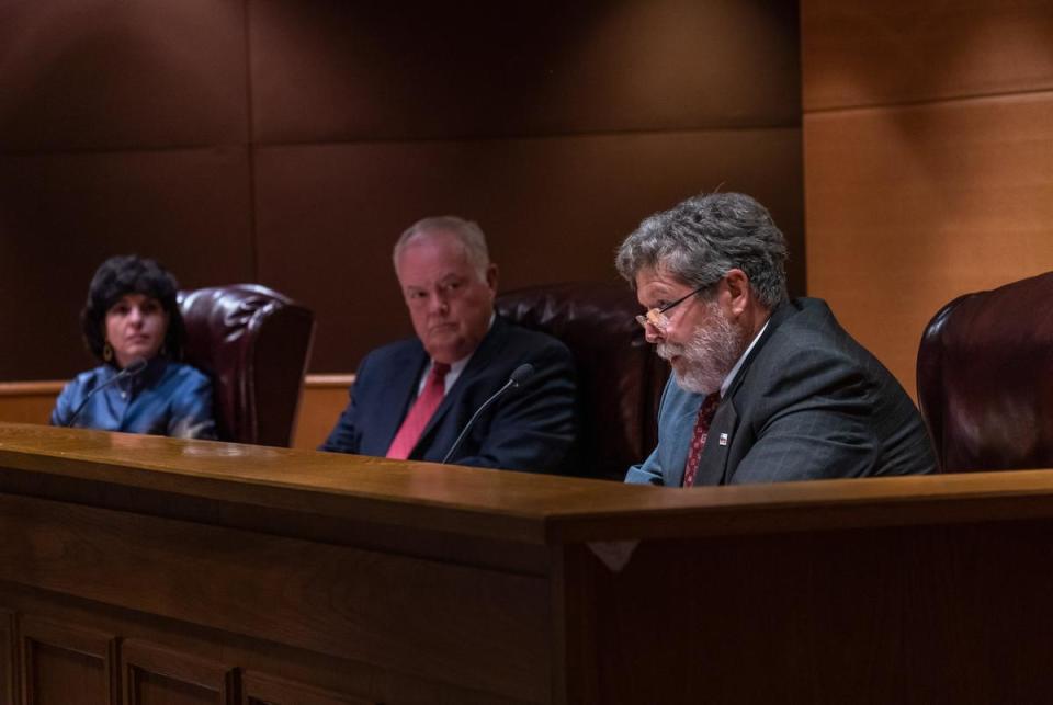 Christi Craddick, Commissioner of the Texas Railroad Commission, Chairman Wayne Christian, and Commissioner Jim Wright listen during an RRC hearing in the William B. Travis Building in Austin on Nov. 30, 2021.