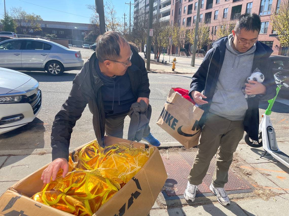 Shihai Zhang and his son, Willliam Zhang, pack up the supplies they planned to use during the Raleigh Christmas Parade. The event was canceled before they were able to walk in the parade.