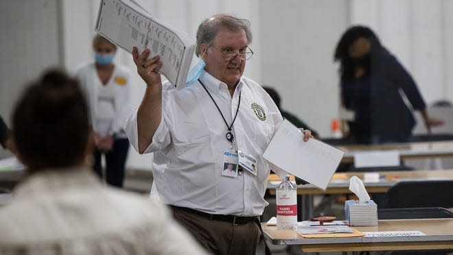 Chatham County Board of Elections Trainer Billy Wooten retrieves counted ballots from workers during the presidential election hand audit in December. Wooten was named interim elections supervisor last Friday.