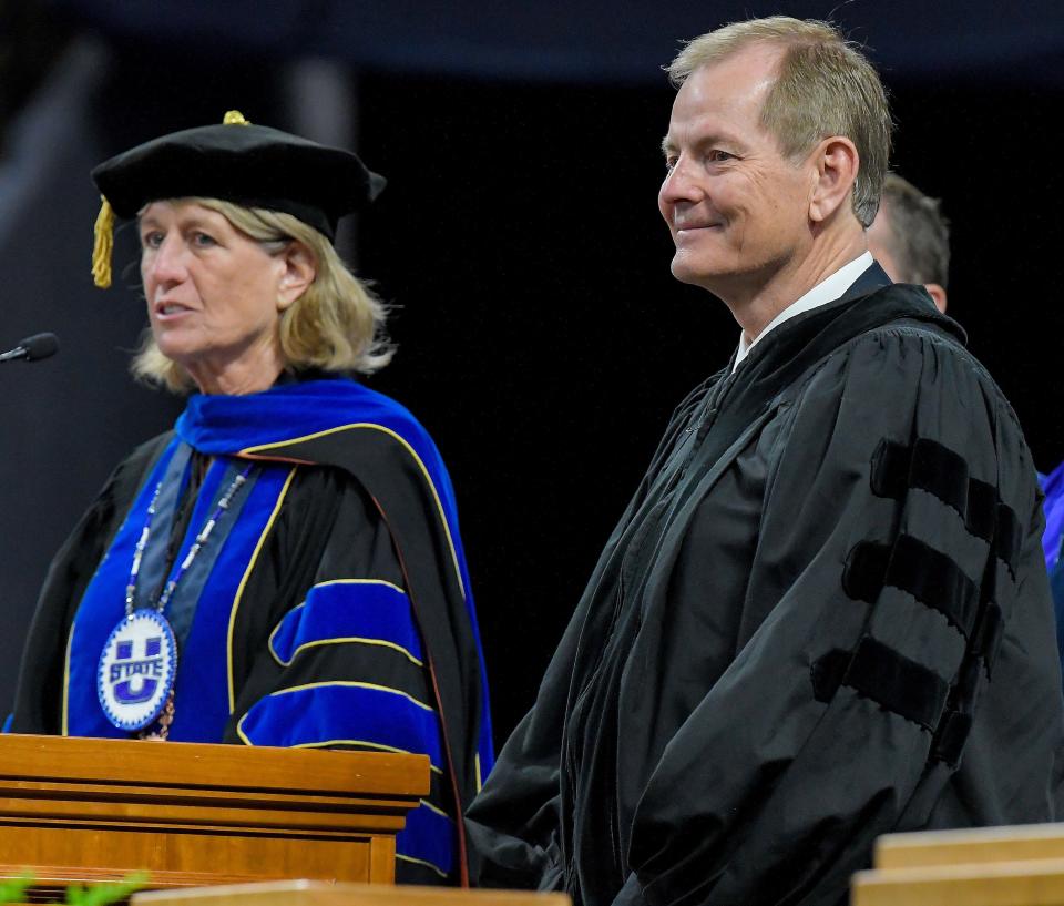 President Noelle Cockett, left, bestows an honorary degree of Doctor of Business to Elder Gary E. Stevenson during Utah State University’s commencement ceremony on Thursday, May 4, 2023, in Logan, Utah. | Eli Lucero, Herald Journal