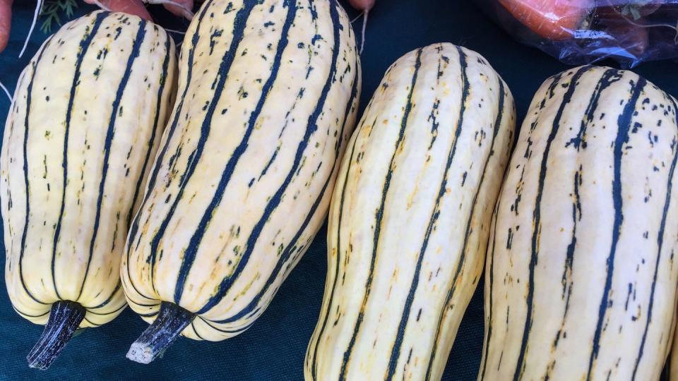 Delicata Squash And Carrots For Sale At Market Stall