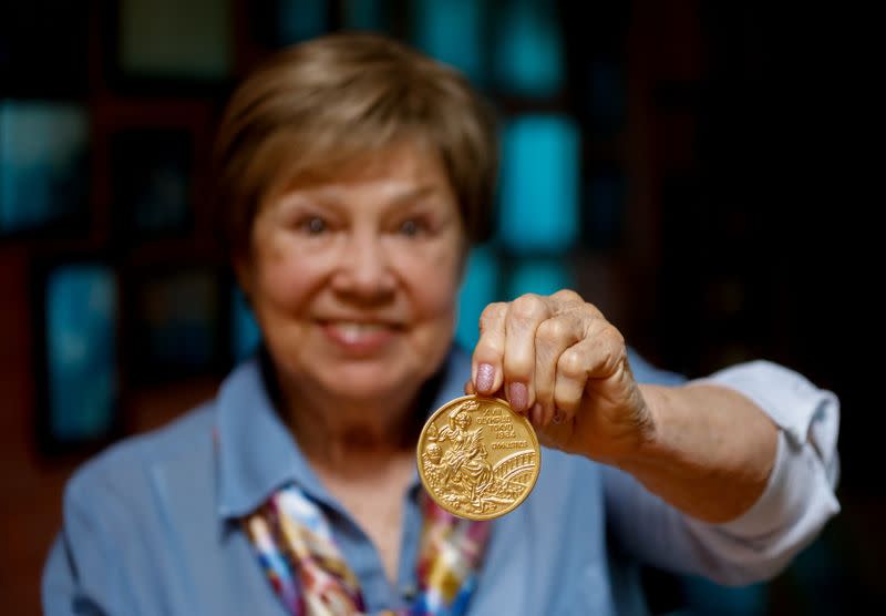 Legendary Soviet gymnast Larisa Latynina shows her Olympic gold medal got in the Olympic Games in Tokyo in 1964, in her home in village Kalyanino