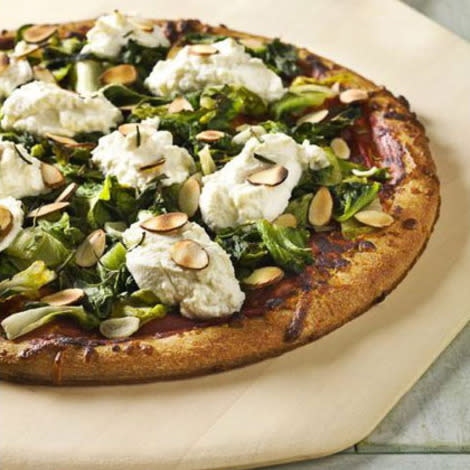 Pizza with wilted greens, ricotta, and almonds