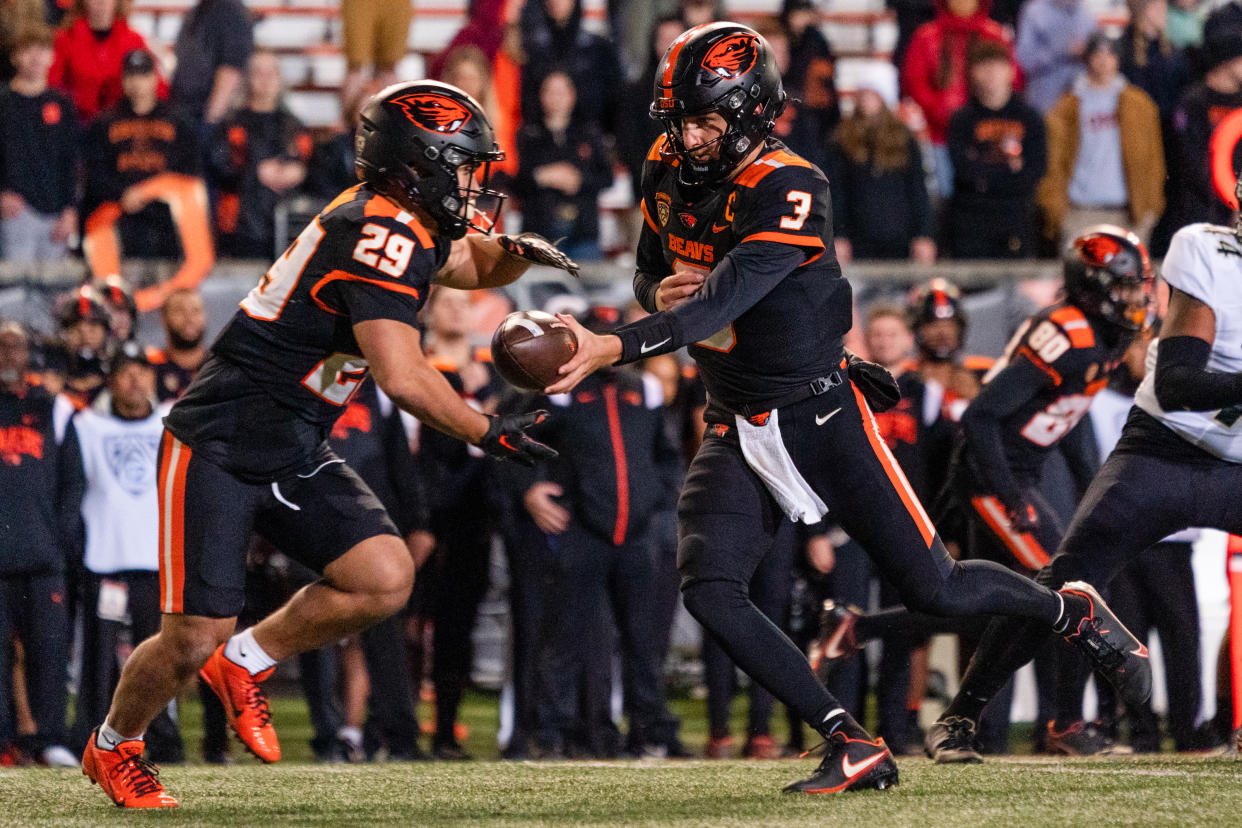 CORVALLIS, OR - OCTOBER 22:  Quarterback Tristan Gebbia #3 of the Oregon State Beavers hands off the ball to running back Kanoa Shannon #29 during the second half of the game against the Colorado Buffaloes at Reser Stadium on October 22, 2022 in Corvallis, Oregon. The Beavers went on to win 42-9. (Photo by Ali Gradischer/Getty Images)