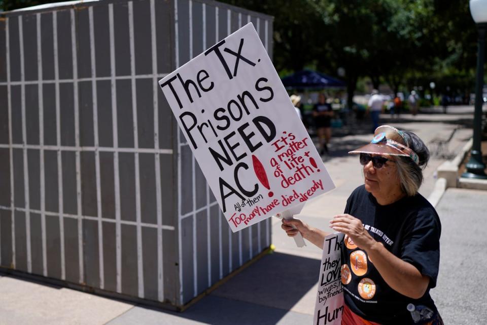 An advocate for cooling Texas prisons walks past a makeshift cell during a rally on the steps of the Texas Capitol, Tuesday, July 18, 2023, in Austin, Texas. The group is calling for an emergency special session to address the deadly heat effecting inmates. (Copyright 2023 The Associated Press. All rights reserved)