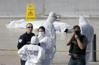 <p>Investigative police officer work by a body under a white sheet outside Marseille ‘s main train station Oct. 1, 2017 in Marseille, southern France. (AP Photo/Claude Paris) </p>