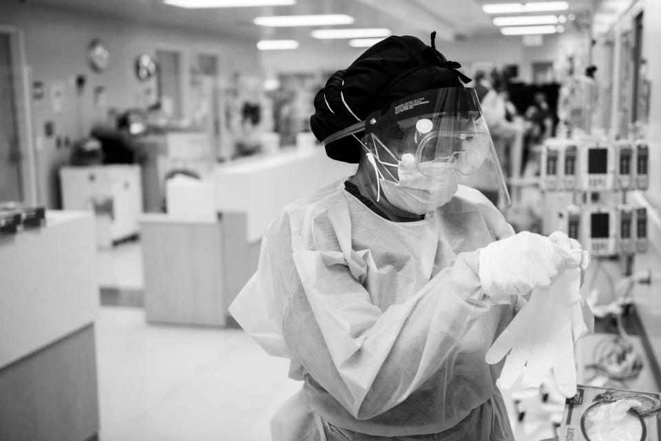 A nurse dons personal protective equipment to attend to patients in a COVID-19 intensive care unit at Martin Luther King Jr. Community Hospital on Jan. 6 in Los Angeles.