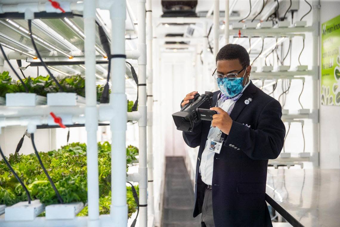 Jathan Briscoe, a 12th grader at Carter G. Woodson Academy, takes video of AppHarvest’s first container farm in an urban location, which is located outside the school, in Lexington, Ky., on Friday, Sept. 17, 2021.