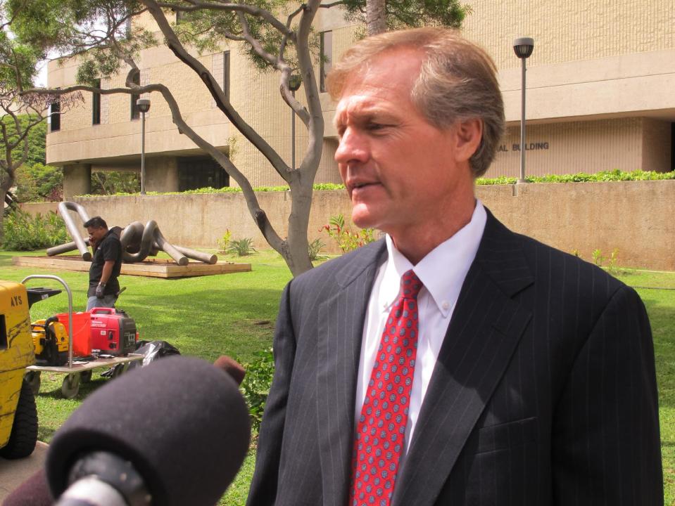 FILE - This March 22, 2013 file photo shows Birney Bervar, attorney for defense contractor Benjamin Bishop, speaking with reporters outside U.S. District Court in Honolulu, Friday, March 22, 2013. Bishop, a civilian defense contractor accused of giving military secrets to a Chinese girlfriend, was expected to plead guilty his attorney said Tuesday March 11, 2014. An FBI affidavit in 2013 alleged the then-59-year-old gave his 27-year-old girlfriend classified information about war plans, nuclear weapons, missile defenses and other topics. (AP Photo/Audrey McAvoy, File)