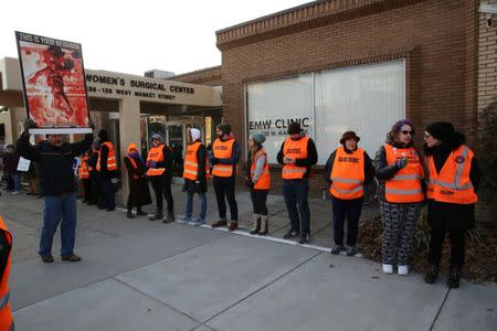 Protesters and escorts who ensure women can reach the clinic face off outside the EMW Women's Surgical Center in Louisville, Kentucky, U.S. January 27, 2017. REUTERS/Chris Kenning