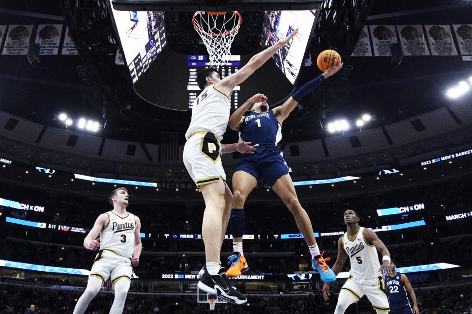 Penn State guard Seth Lundy, center right, drives to the basket against Purdue center Zach Edey during the first half of an NCAA college basketball championship game at the Big Ten men's tournament, Sunday, March 12, 2023, in Chicago. (AP Photo/Nam Y. Huh)