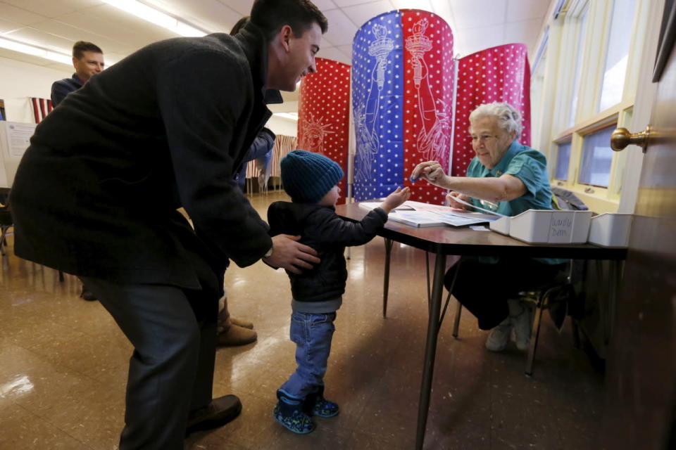 A child hands in a voting token in Manchester