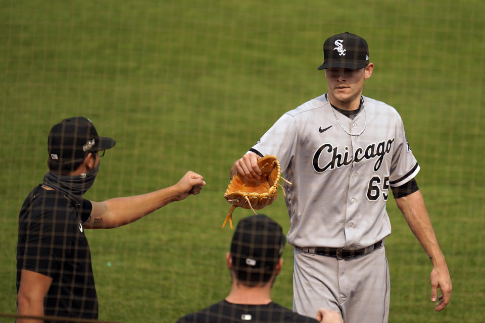 Chicago White Sox pitcher Codi Heuer, right, is greeted by teammates after retiring the Oakland Athletics in the third inning of Game 3 of an American League wild-card baseball series Thursday, Oct. 1, 2020, in Oakland, Calif. (AP Photo/Eric Risberg)