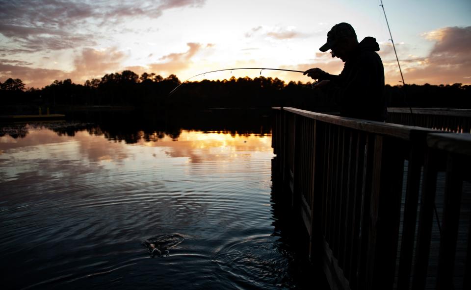 Jim Cripps reels in a fish at Lake Rim.