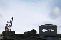 The logo of the Venezuelan oil company PDVSA and cut-outs depicting oil facilities are seen on a building of the company in Caracas, Venezuela July 21, 2016. Picture taken July 21, 2016. REUTERS/Carlos Garcia Rawlins