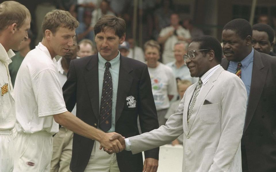 England captain Mike Atherton is presented to Zimbabwe's despotic president, Robert Mugabe -  Getty Images