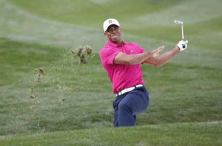 Tiger Woods blasts out of a fairway bunker on the 9th hole during the first round of the Waste Management Phoenix Open at TPC Scottsdale. Mandatory Credit: Rob Schumacher-Arizona Republic via USA TODAY Sports