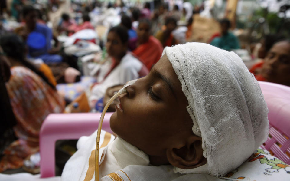 An 8-year-old boy recovering from a head operation lies unconscious as patients were evacuated from a government hospital following a tremor in Chennai, India, Wednesday, April 11, 2012. There were no signs of deadly waves, however, or serious damage, and a watch for much of the Indian Ocean was lifted after a few hours. (AP Photo/Arun Shanker)